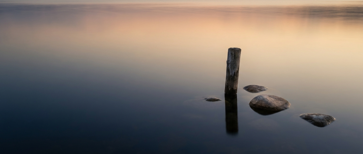 Individual Therapy Mount Pleasant, SC — calm still water reflecting a soft dawn sky