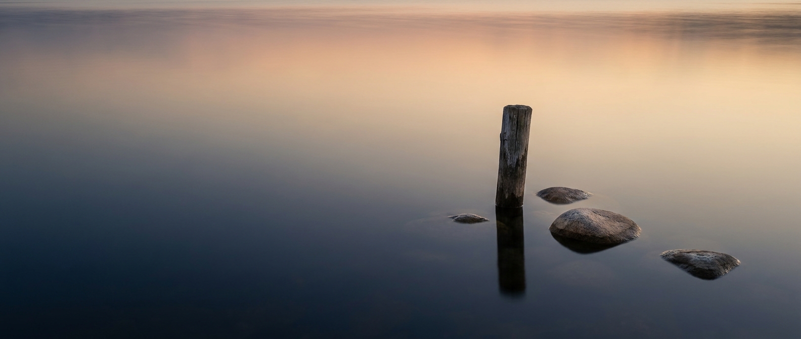 Individual Therapy Mount Pleasant, SC — calm still water reflecting a soft dawn sky