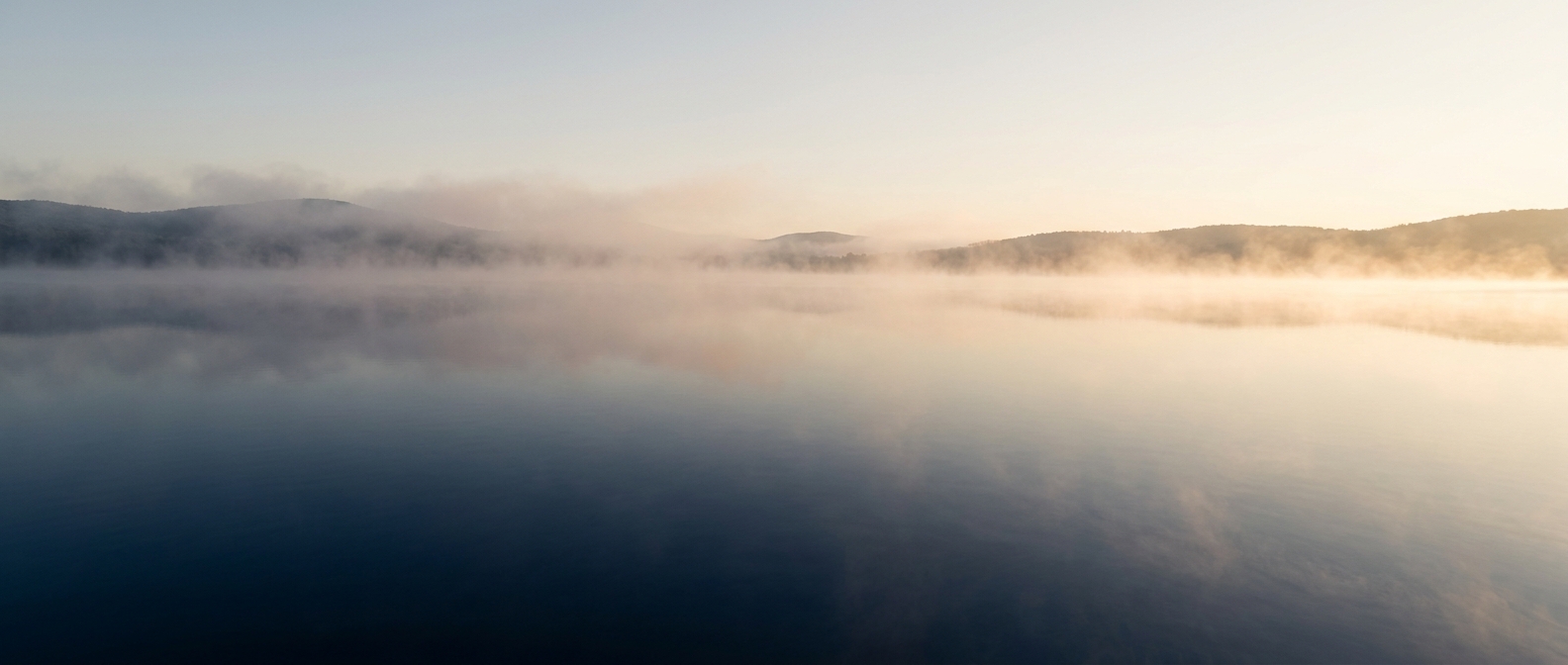 Narcissistic Abuse Recovery Therapy — clear calm water and open sky as morning fog gently lifts